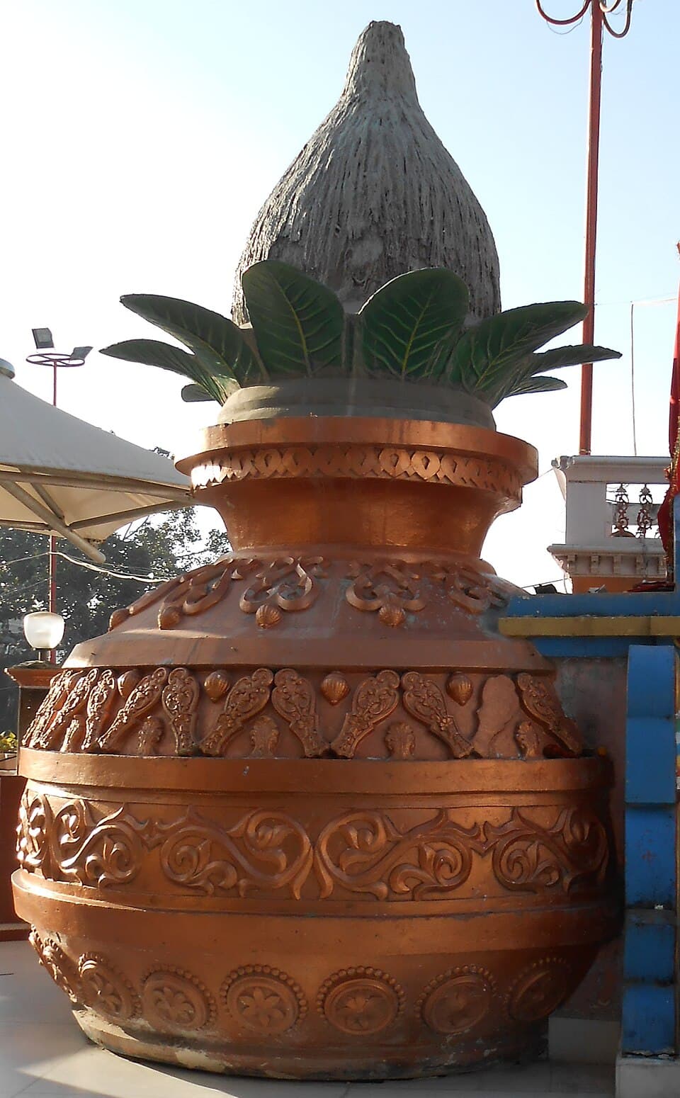 Kalasha with coconut and mango leaves at a wedding